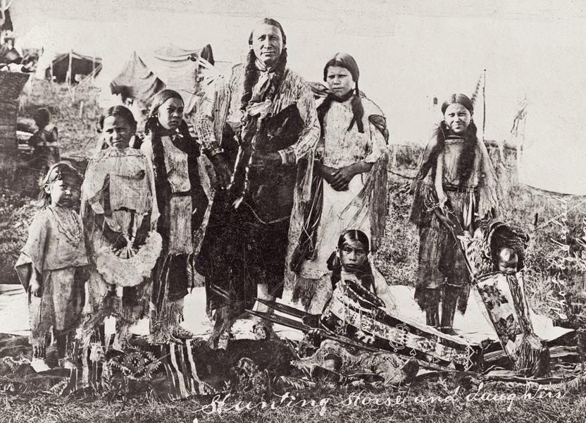 Hunting Horse and DaughtersKiowa leader Hunting Horse stands with his daughters in this 1908 photograph by J.V. Dedrick of Taloga, Oklahoma. He served as a scout for Gen. George Custer, and he lived to be 107, dying in the same year, 1953, when this magazine was founded.– Courtesy Library of Congress –