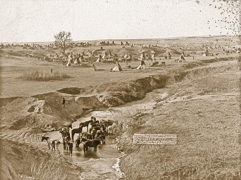 Brulé Tipi VillageIn 1891, John Grabill’s camera captured this view of a Brulé Lakota tipi camp, near South Dakota’s Pine Ridge Reservation, with their horses stationed at the White Clay Creek watering hole.– Courtesy Library of Congress –