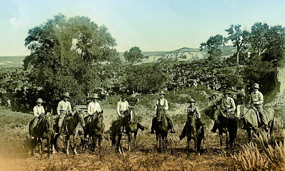 Keeping Their DistanceWilliam Henry Jackson captured this iconic photograph of Texas cowboys with their herd behind them. “We always rode something like seventy-five feet away from the cattle, and sang a song or made some kind of noise,” recalled Evan G. Barnard, who became a Cherokee Strip cowpuncher in 1882. “That was done so that the cattle would not be frightened if we happened to have to ride near them suddenly. If they heard us singing or humming a tune, they knew what was coming. Also the noise we made kept the coyotes away from the herd. They often prowled around and scared the cows that had calves.”–Courtesy Library of Congress –