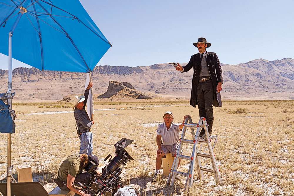 Familiar frontier character Wyatt Earp is cast in a world where who was an outlaw and who was the law was often a matter of who was winning the West (Earp is played by Jonathan C. Stewart, standing on a ladder on the set of AMC’s The American West). The series is not perfect. George Custer fans may be furious (although they usually are); the show could have at least dyed actor John C. Bailey’s hair blond. – Earp photo by Michael Moriatis / AMC; Custer photo By Lawrence French / Getty Images for AMC –