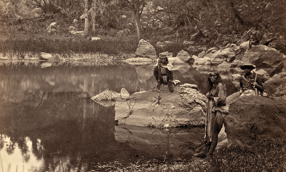 BOW_Books_LEAD_View-on-Apache-Lake,-Sierra-Blanca-Range,-Arizona.-Two-Apache-scouts-in-the-foreground--1873--T.-H